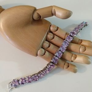 Costume jewelry bracelet with purple faux gems